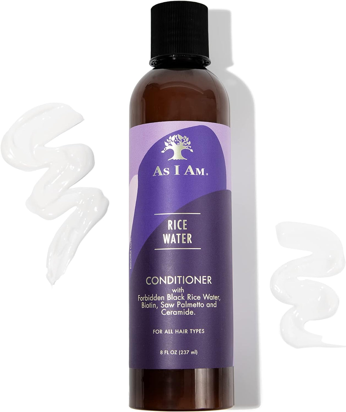 A brown bottle of As I Am Rice Water Conditioner (237ml) with purple label showing product name, ingredients and quantity. Two white blobs of the product are also shown in the picture.