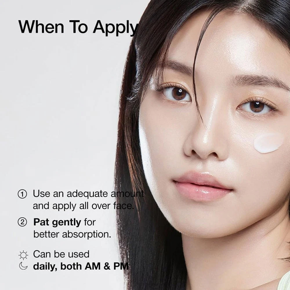 Woman with smooth skin and cream on cheek shows application of face cream Cosrx Moisture Power Enriched Cream.