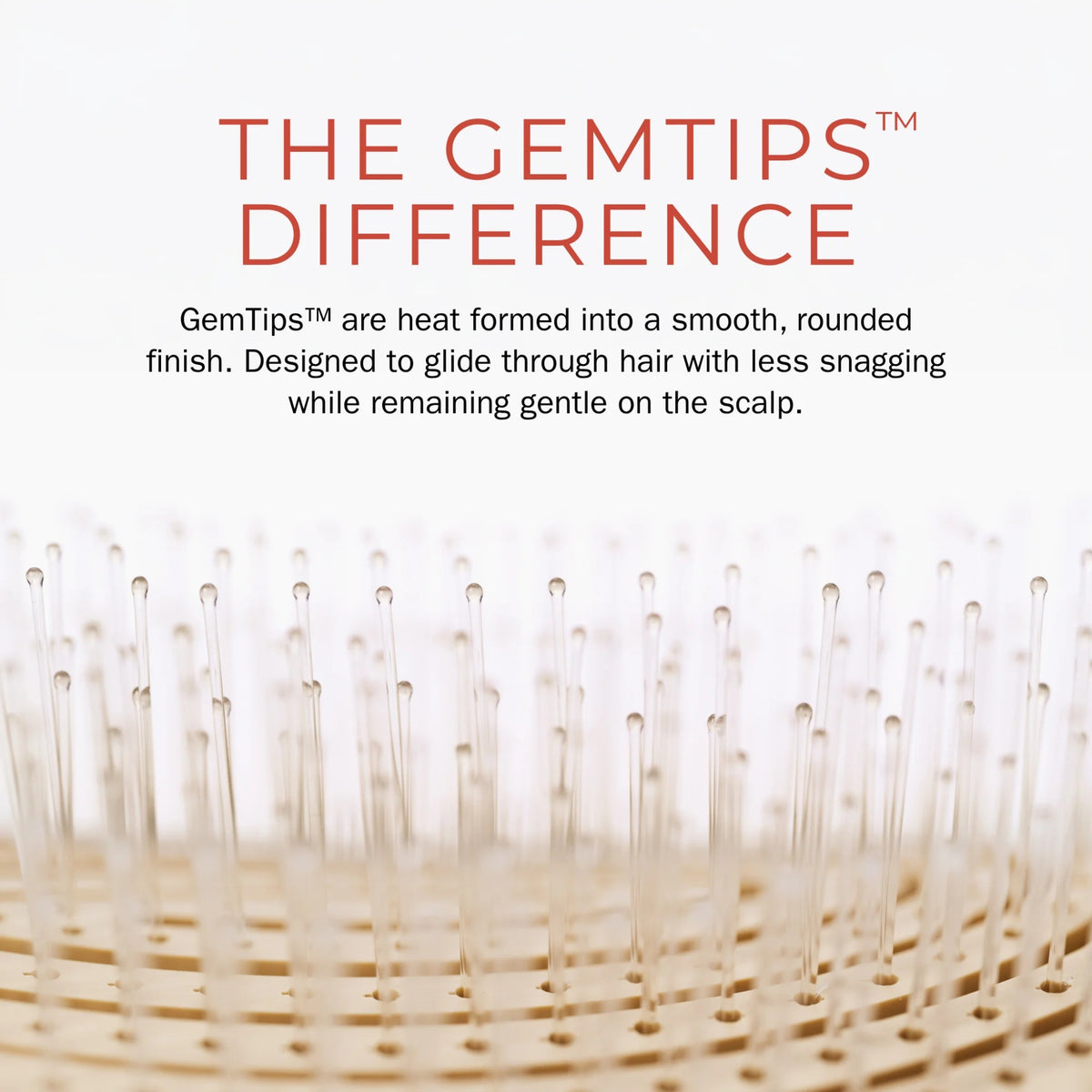 Close-up of GemTip's hair brush with rounded, smooth light wood bristle tips that glide through the hair.