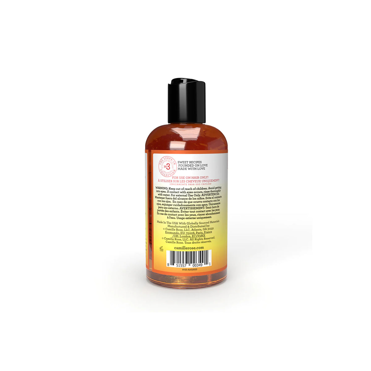 Back of a golden bottle of Camille Rose Honey Hydrate Leave-In Conditioner.