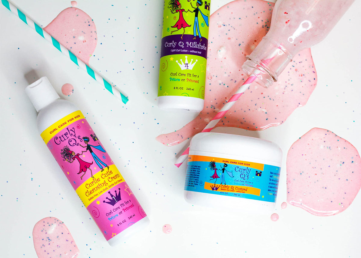 Product line Curls Curly Q's for children. Includes Moist Curls Moisturizer and Detangler, Curlie Cutie Cleansing Cream and an unknown Milkshake variant. White bottles and jar with colorful labels on white background with pink "milkshake" spots and straws.