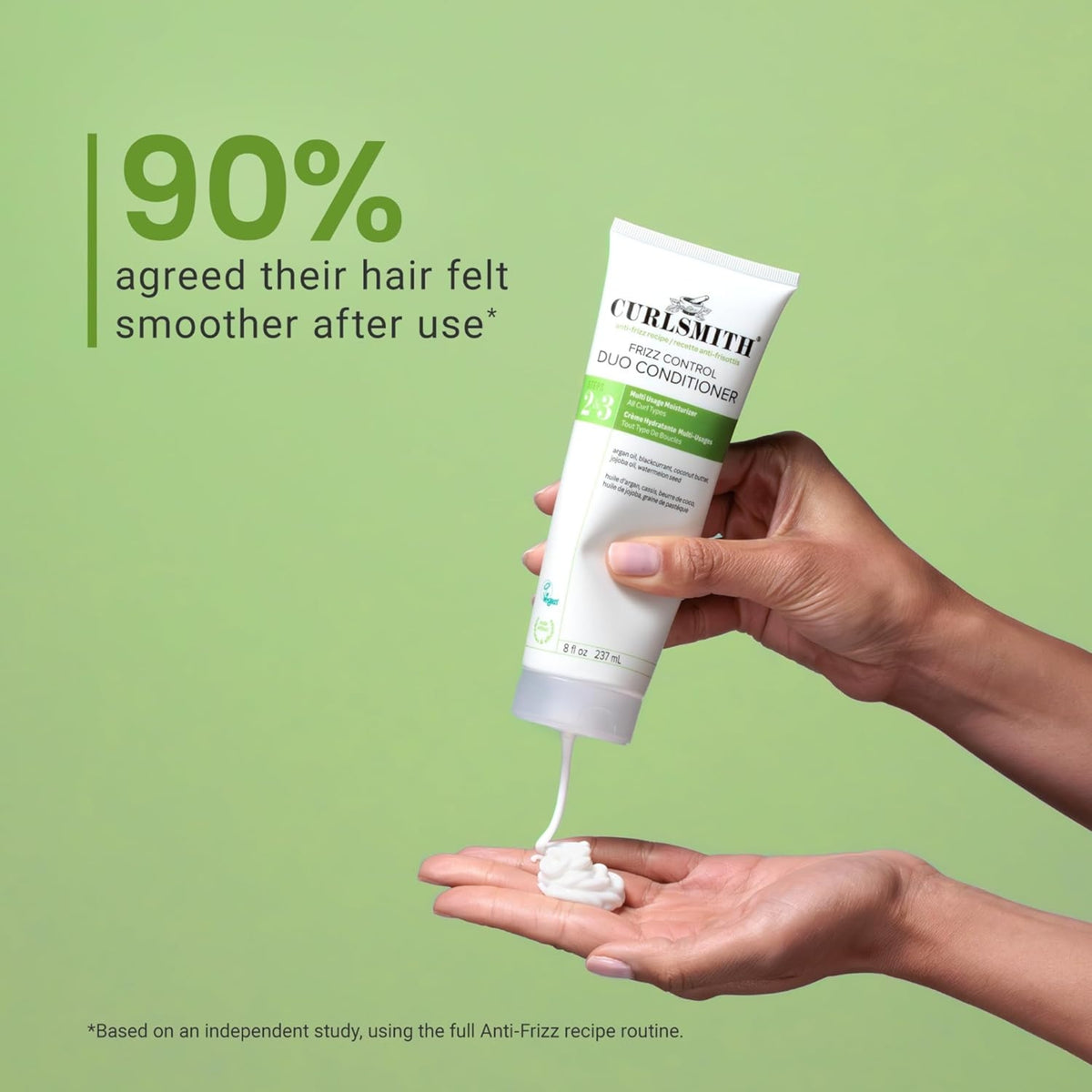 Curlsmith Frizz Control Duo Conditioner is squeezed out in hand, 90% experienced smoother hair after use.