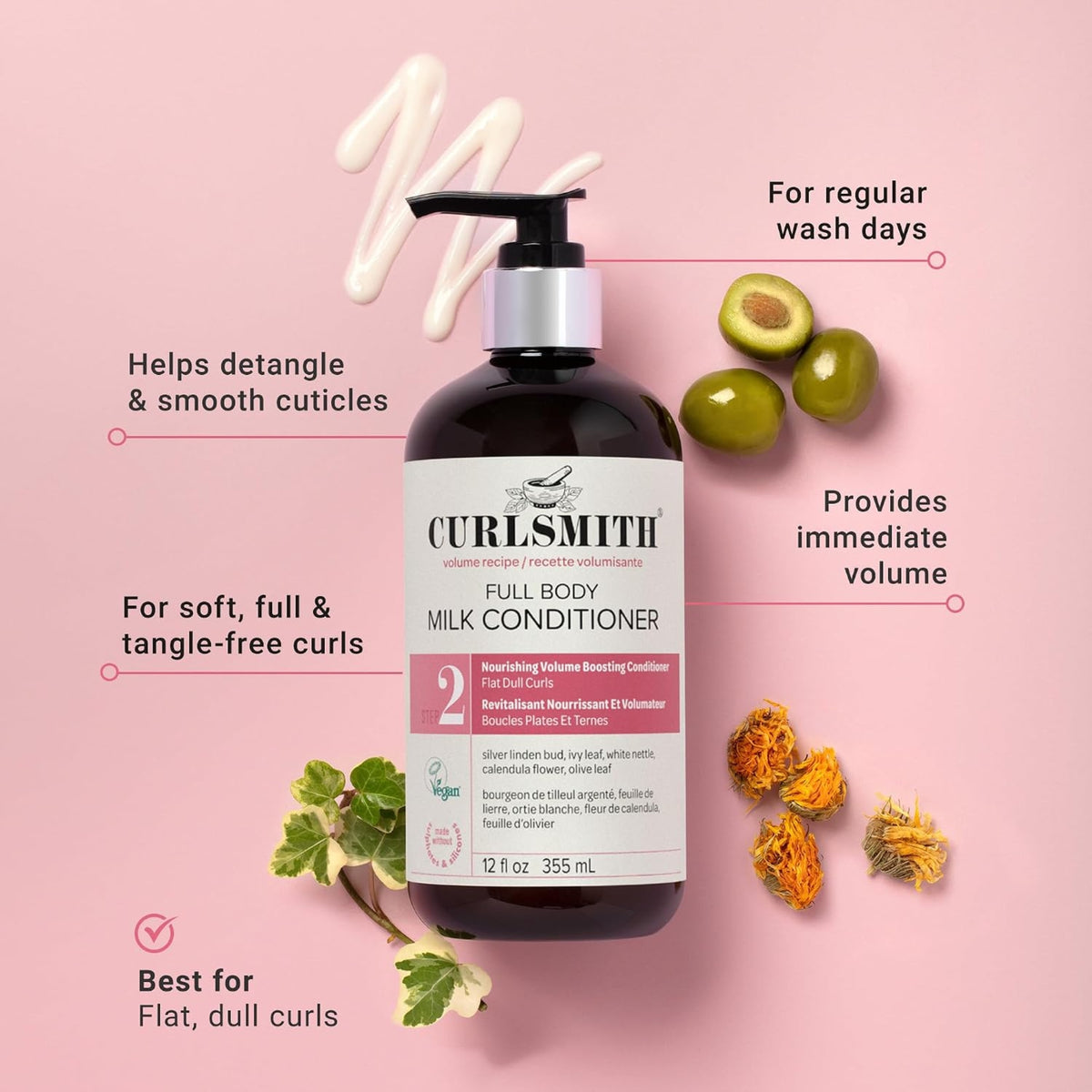 Curlsmith Full Body Milk Conditioner bottle on light pink background with olives, ivy leaves and calendula flowers.