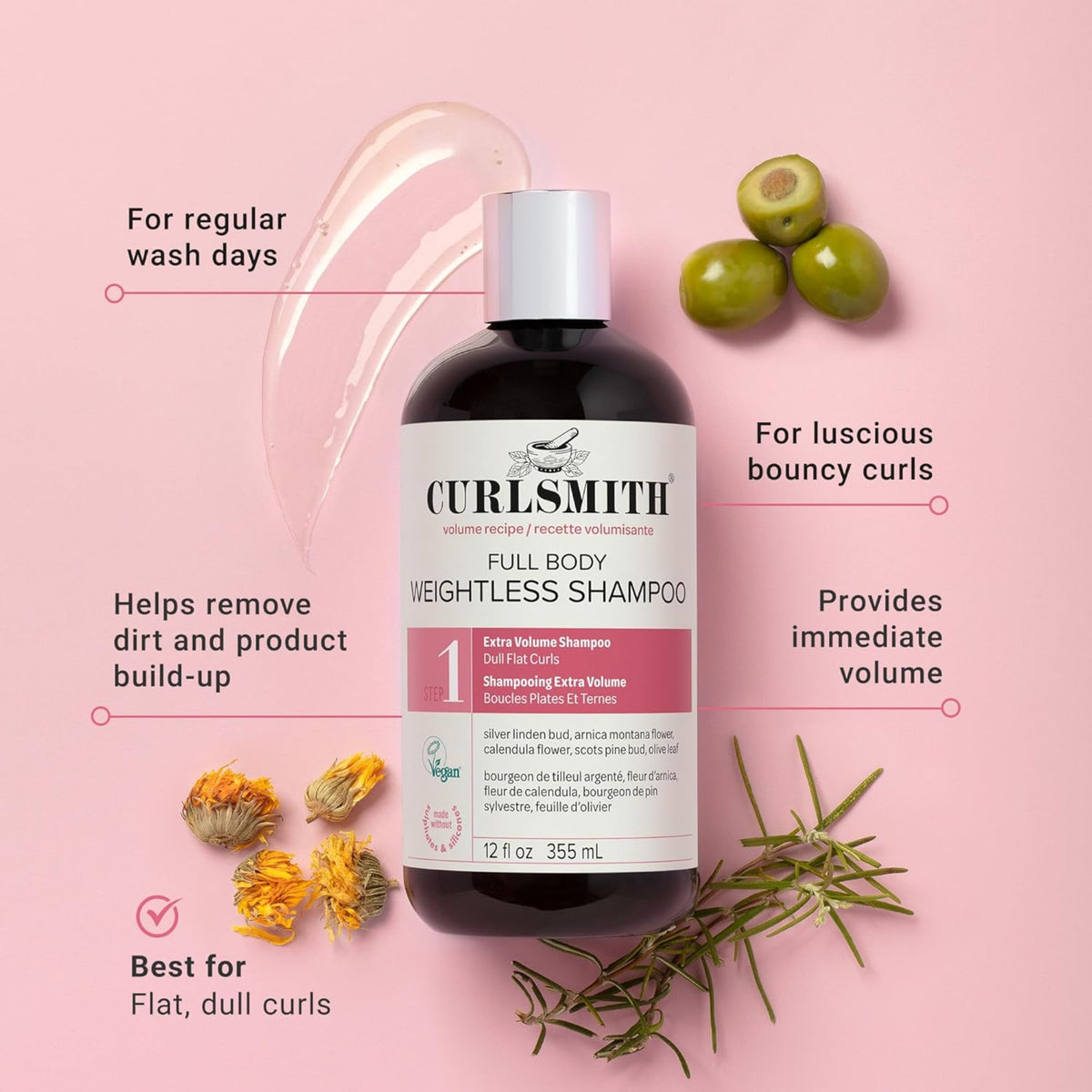 Curlsmith Full Body Weightless Shampoo bottle on pink background with olives, marigolds and rosemary.