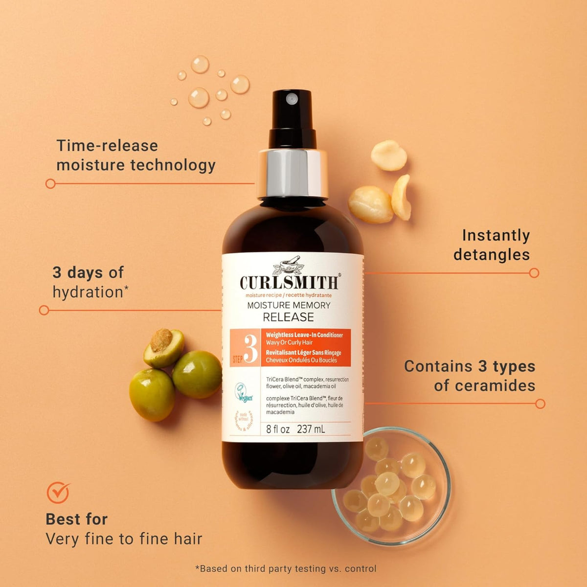 Curlsmith Moisture Memory Release leave-in spray with olives, macadamia nuts and hydrogel pearls on a peach background.