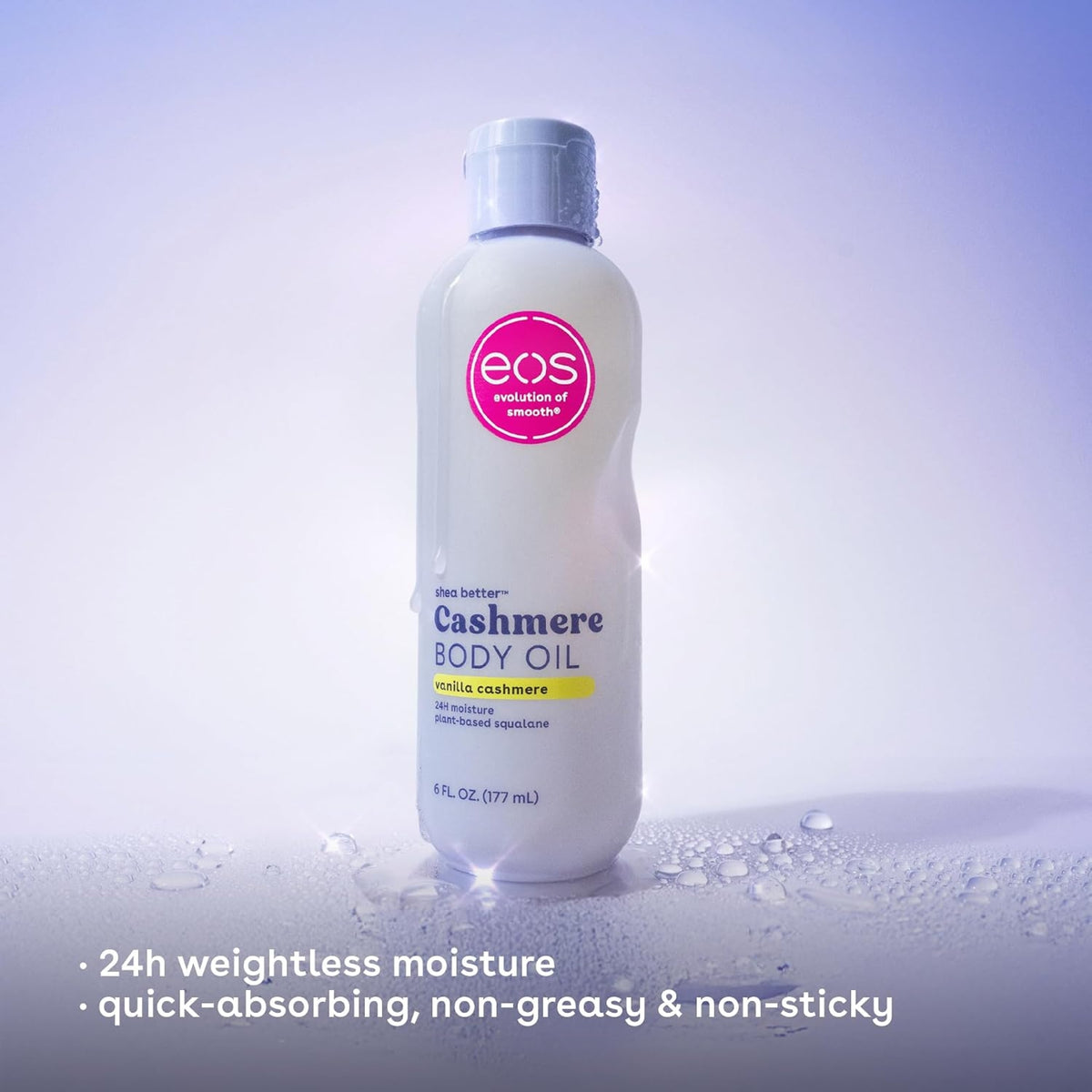 eos Shea Better Cashmere Body Oil in vanilla cashmere scent, white bottle with pink logo on wet surface.