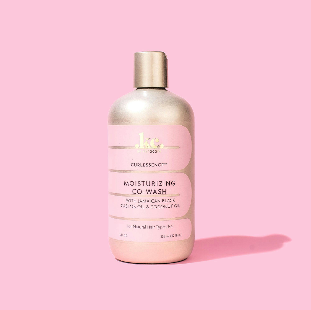 KeraCare Curlessence Moisturizing Co-Wash 355ml in pink bottle with gold lid against pink background.