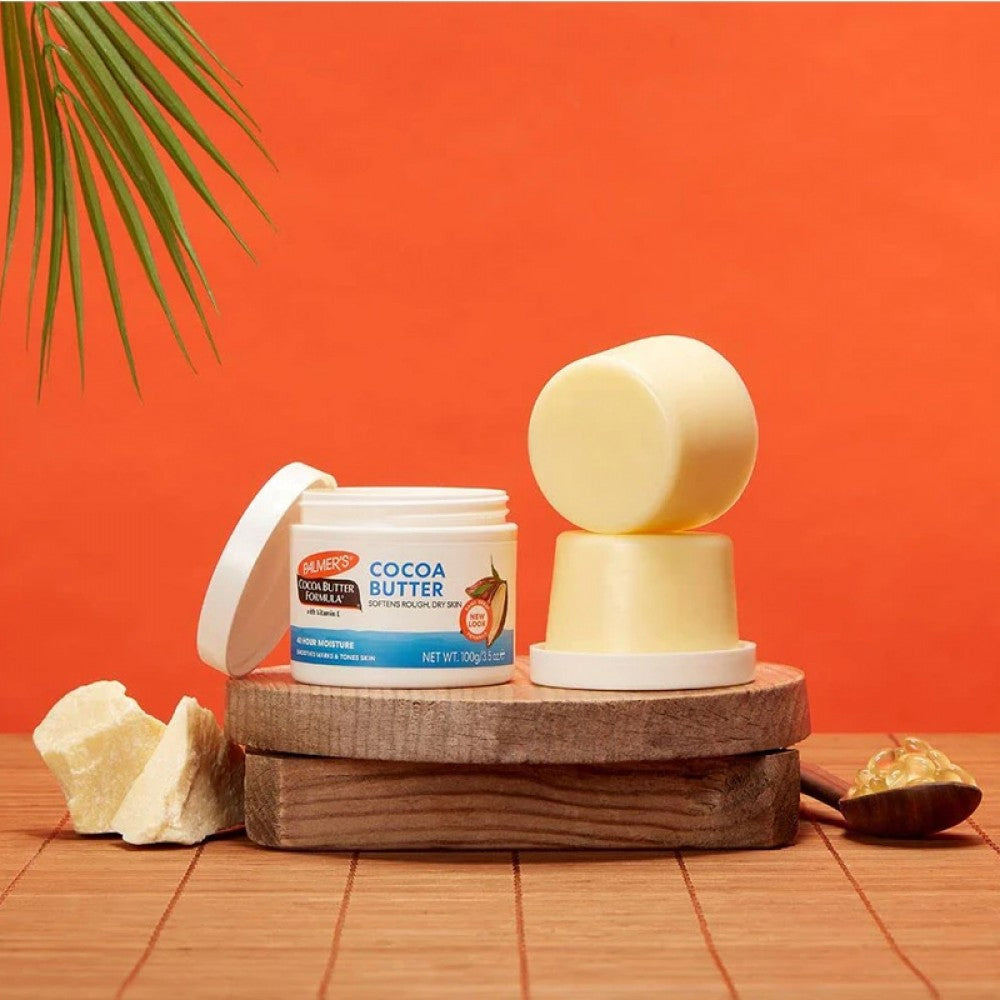 Palmer's Cocoa Butter Formula Cream (100g) jar shown with solid and melted cocoa butter.