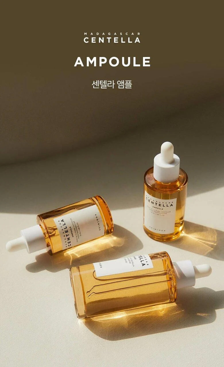 Three bottles of SKIN1004 Madagascar Centella Ampoule 30ml in golden light on beige surface with shadows and dropper lid.